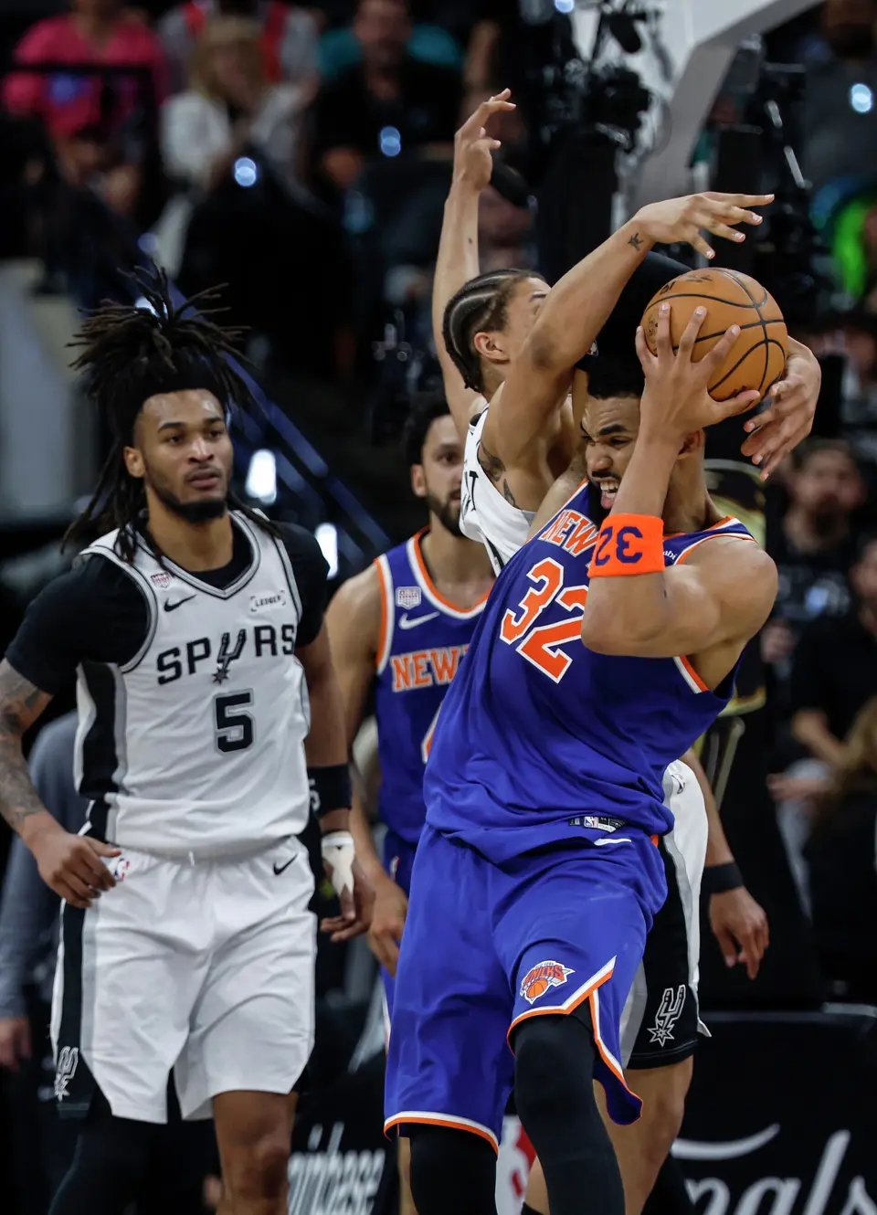 New York Knicks center Karl-Anthony Towns (32) has his shot blocked by San Antonio Spurs forward Carter Bryant (11) during the second quarter of game five of the NBA Championship at Frost Bank Center on Saturday, June13, 2026.