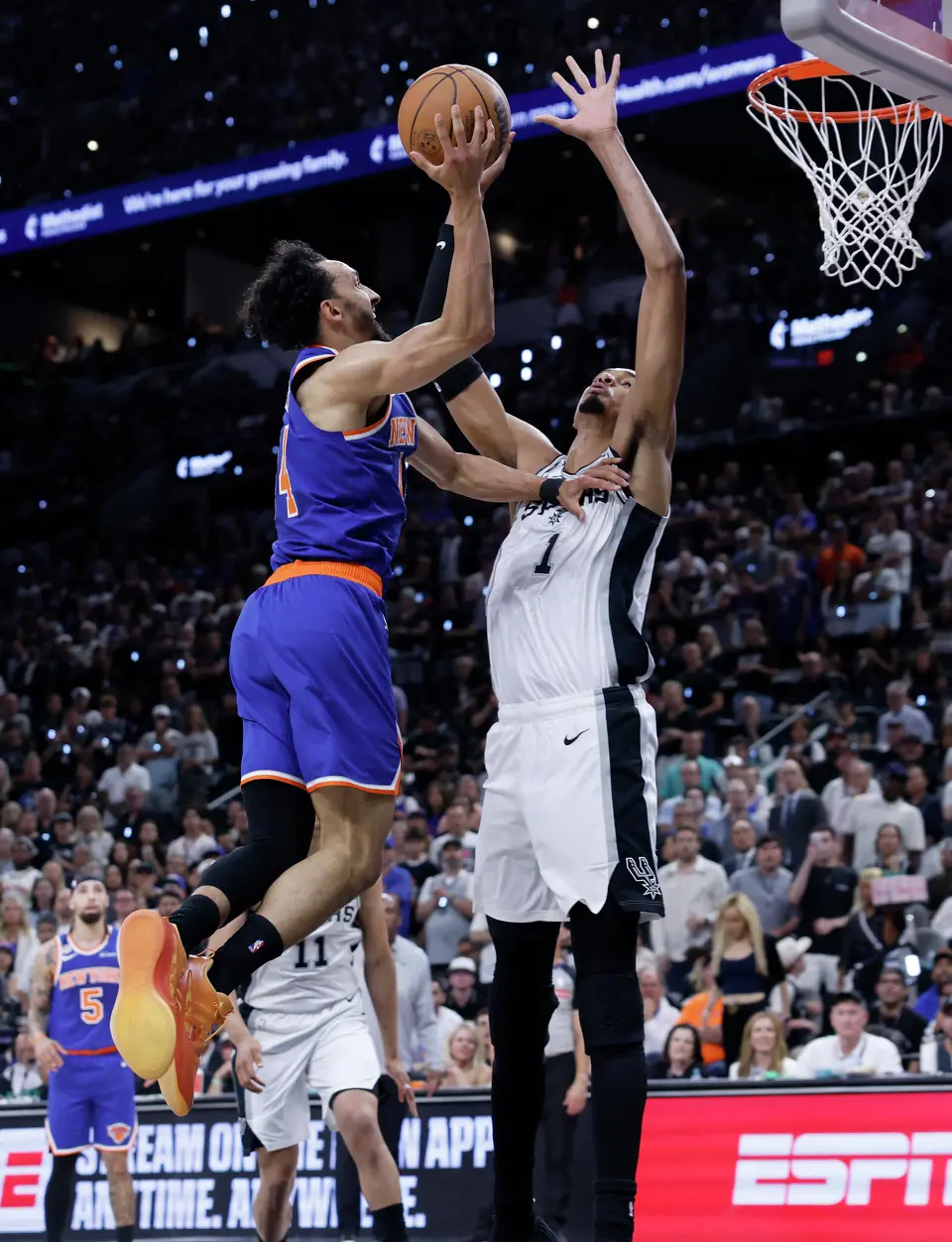 New York Knicks guard Landry Shamet (44) tries to make a shot over San Antonio Spurs center Victor Wembanyama (1) during the second quarter of game five of the NBA Championship at Frost Bank Center on Saturday, June13, 2026.