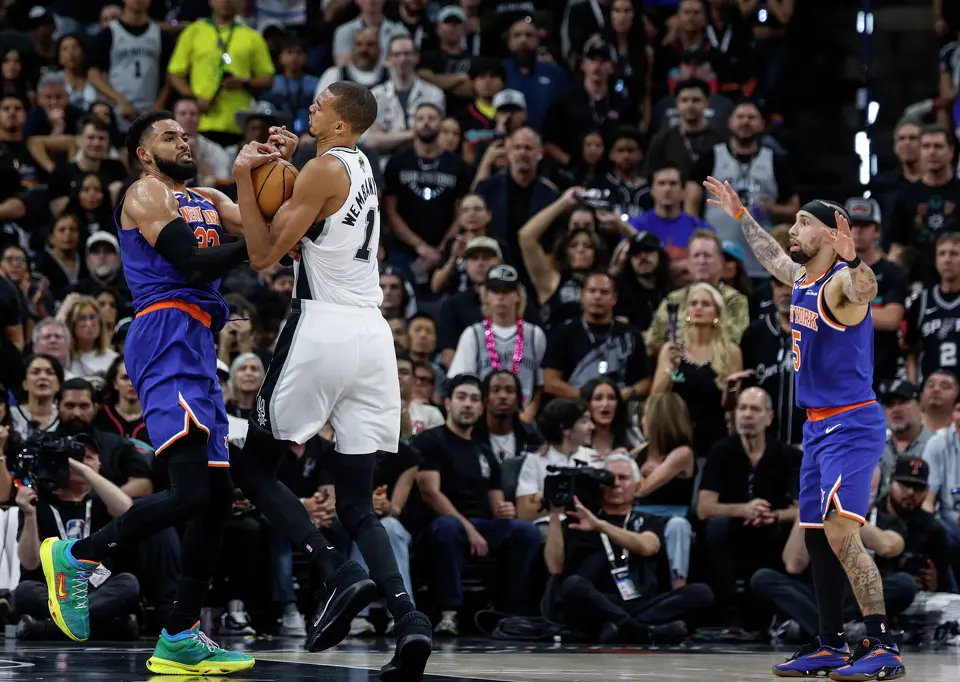 San Antonio Spurs center Victor Wembanyama (1) and New York Knicks center Karl-Anthony Towns (32) fight over a loose ball during the second quarter of game five of the NBA Championship at Frost Bank Center on Saturday, June13, 2026.