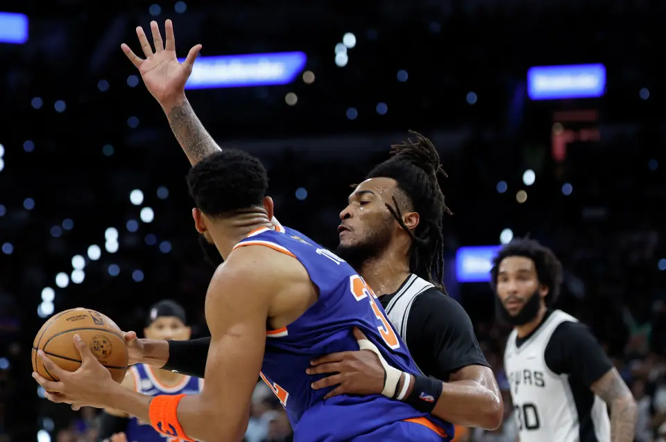 San Antonio Spurs guard Stephon Castle (5) guards New York Knicks center Karl-Anthony Towns (32) during the second quarter of game five of the NBA Championship at Frost Bank Center on Saturday, June13, 2026.