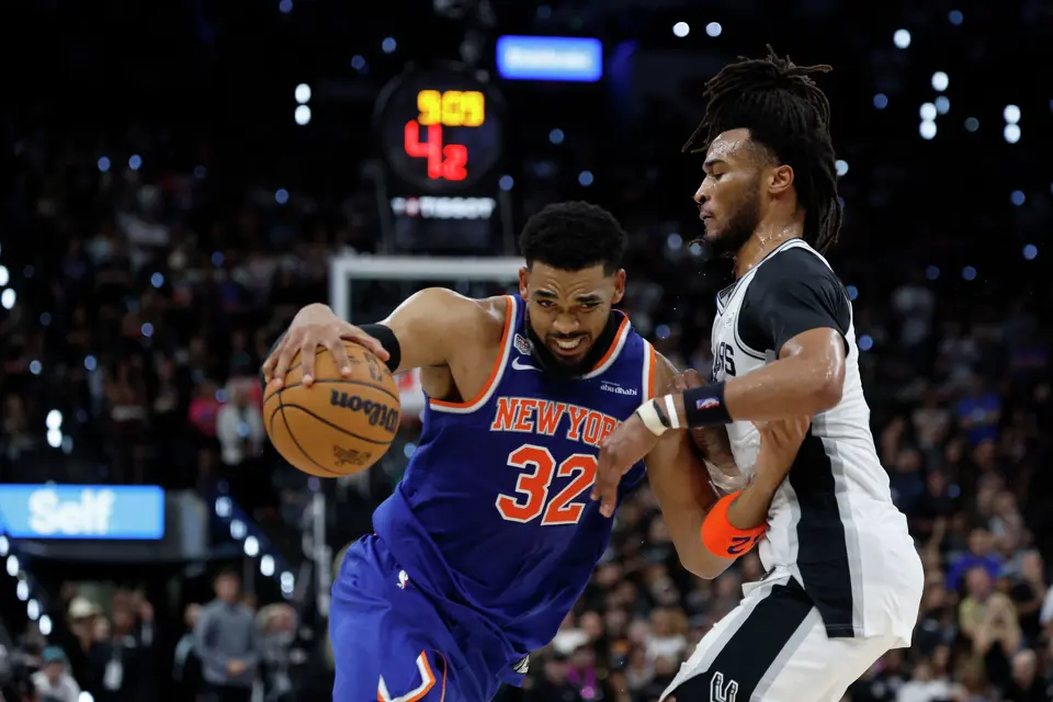 San Antonio Spurs guard Stephon Castle (5) guards New York Knicks center Karl-Anthony Towns (32) during the second quarter of game five of the NBA Championship at Frost Bank Center on Saturday, June13, 2026.