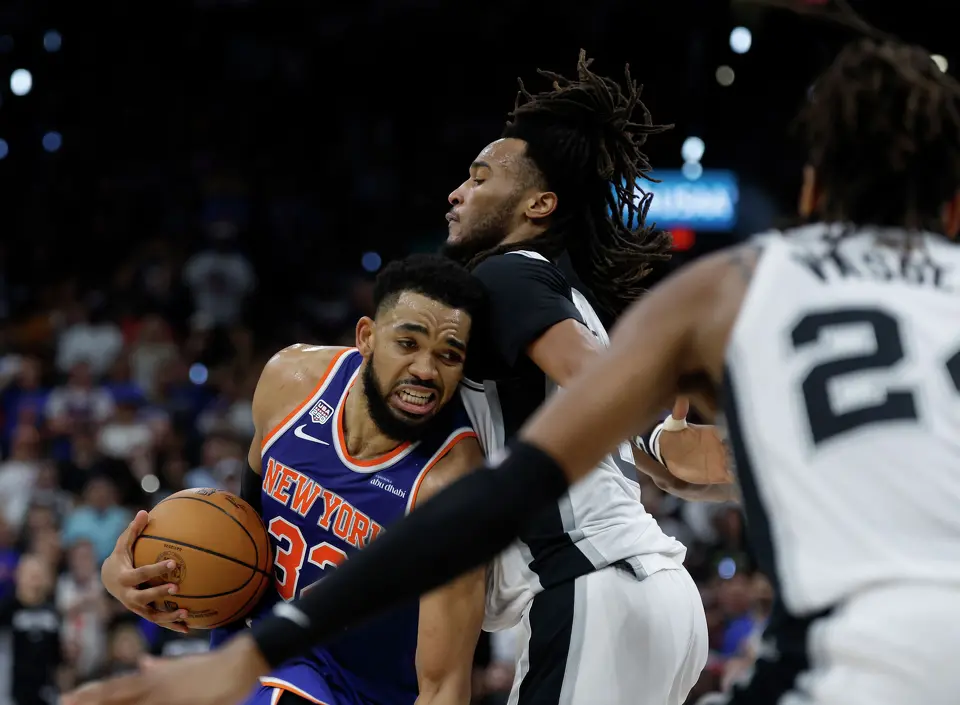 New York Knicks center Karl-Anthony Towns (32) struggles to get past San Antonio Spurs guard Stephon Castle (5) during the second quarter of game five of the NBA Championship at Frost Bank Center on Saturday, June13, 2026.