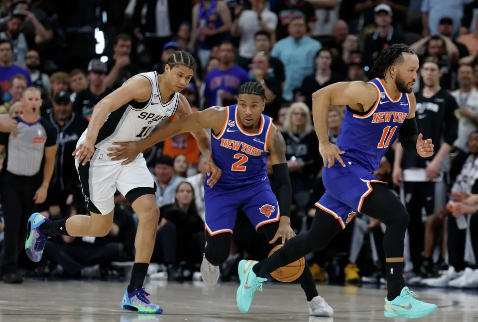 New York Knicks guard Miles McBride (2) brings the ball up the court while being guarded by San Antonio Spurs forward Carter Bryant (11) during the second quarter of game five of the NBA Championship at Frost Bank Center on Saturday, June13, 2026.