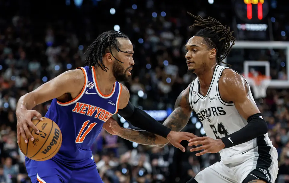 San Antonio Spurs guard Devin Vassell (24) guards New York Knicks guard Jalen Brunson (11) during the second quarter of game five of the NBA Championship at Frost Bank Center on Saturday, June13, 2026.