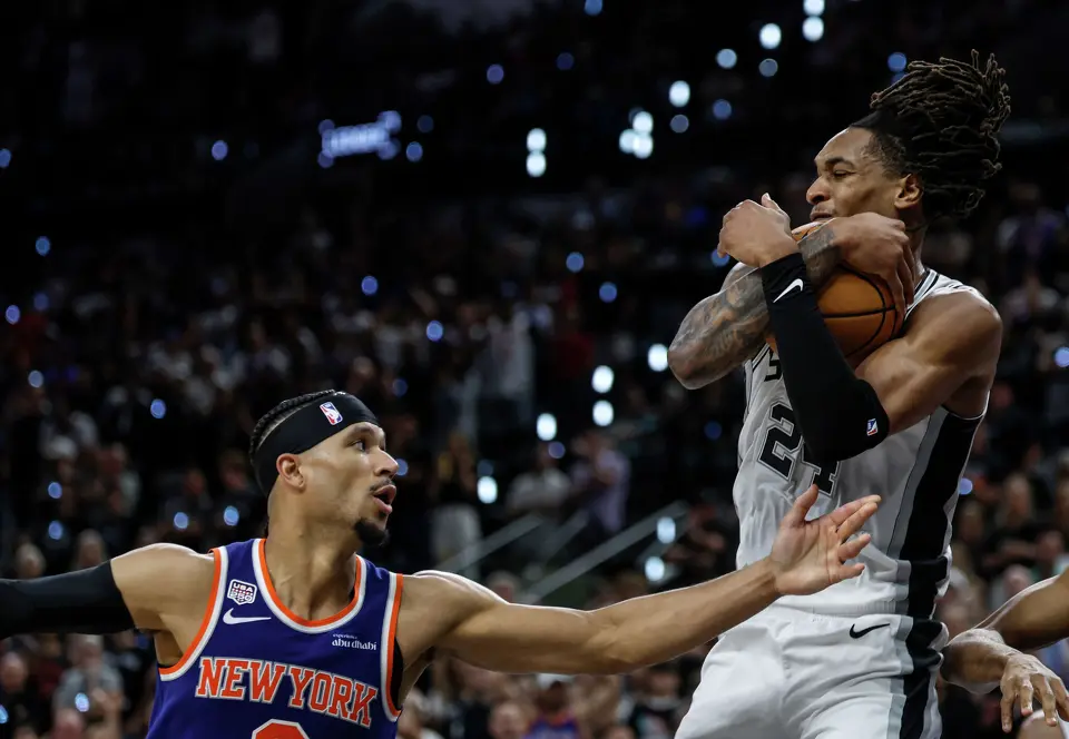 San Antonio Spurs guard Devin Vassell (24) comes down with a rebound over New York Knicks guard Josh Hart (3) during the second quarter of game five of the NBA Championship at Frost Bank Center on Saturday, June13, 2026.
