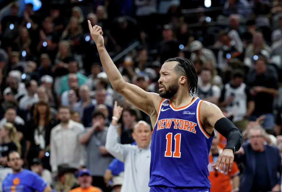 New York Knicks guard Jalen Brunson (11) tries to rile up the crowd during the second quarter of game five of the NBA Championship at Frost Bank Center on Saturday, June13, 2026.