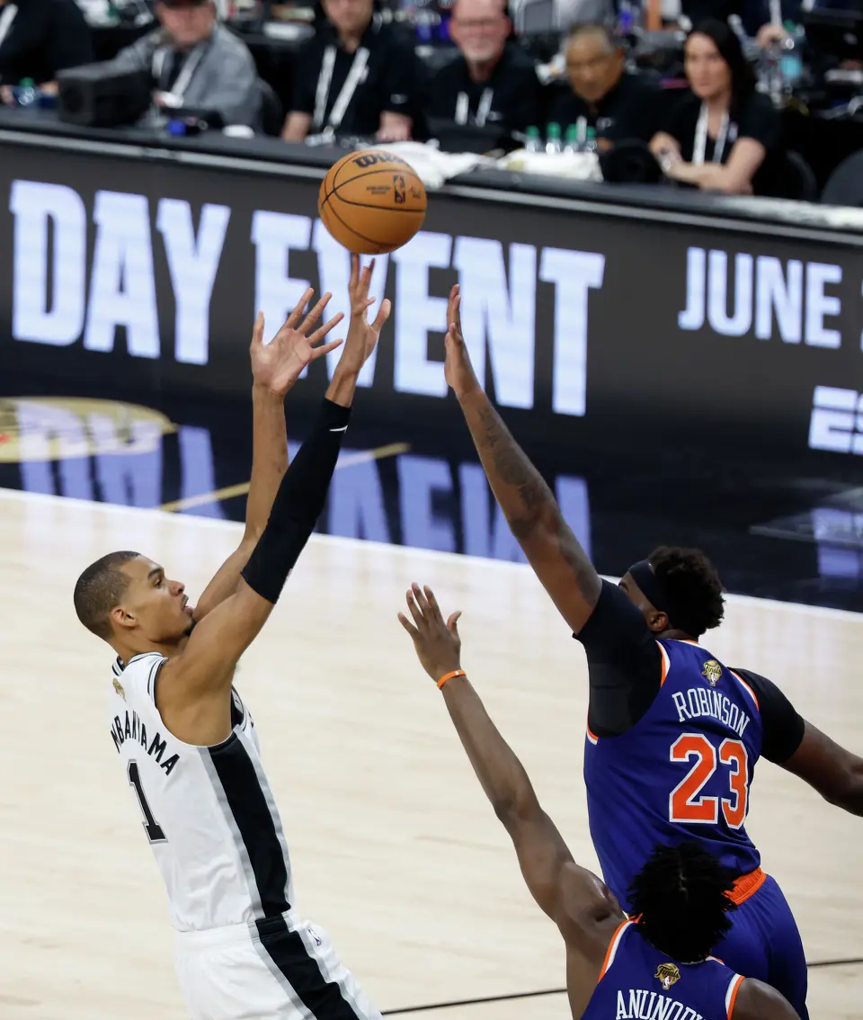 San Antonio Spurs center Victor Wembanyama (1) takes a jump shot over New York Knicks center Mitchell Robinson (23) during the third quarter of game five of the NBA Championship at Frost Bank Center on Saturday, June13, 2026.