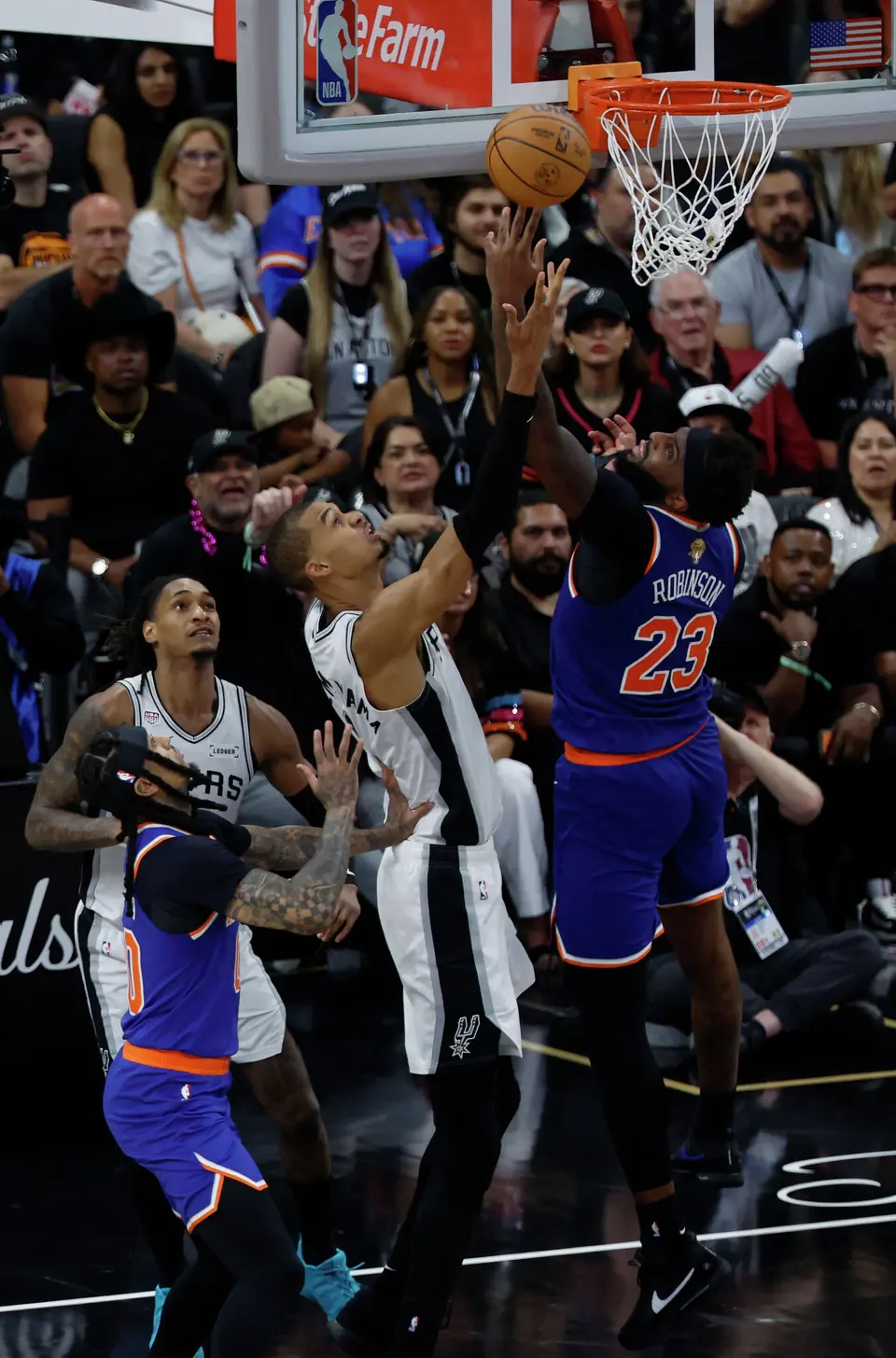 New York Knicks center Mitchell Robinson (23) gets the layup over San Antonio Spurs center Victor Wembanyama (1) during the third quarter of game five of the NBA Championship at Frost Bank Center on Saturday, June13, 2026.