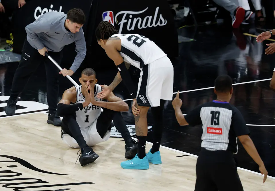 San Antonio Spurs guard Devin Vassell (24) helps San Antonio Spurs center Victor Wembanyama (1) up after a foul during the third quarter of game five of the NBA Championship at Frost Bank Center on Saturday, June13, 2026.