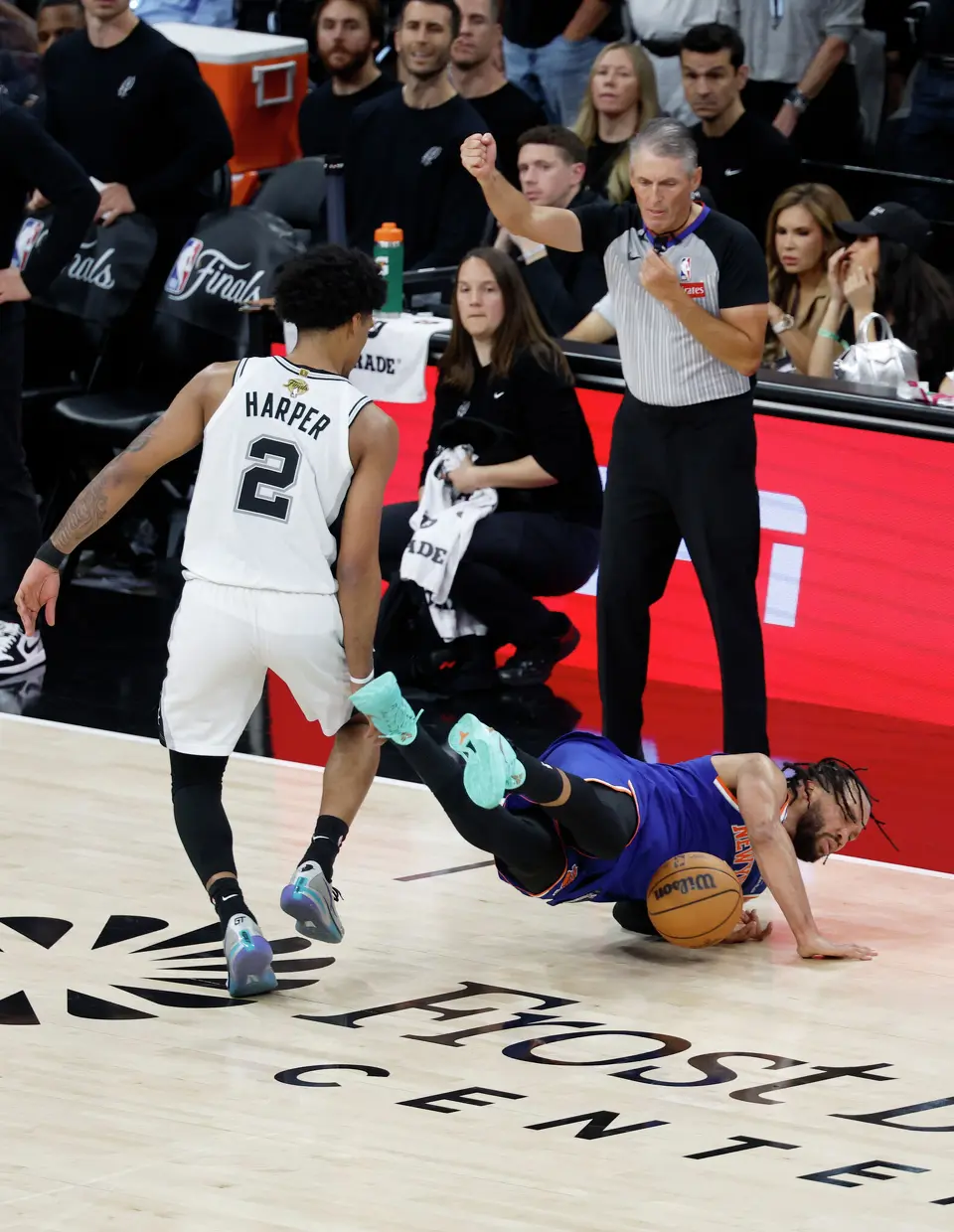 New York Knicks guard Jalen Brunson (11) takes a hard fall after being tripped by San Antonio Spurs guard Dylan Harper (2) during the third quarter of game five of the NBA Championship at Frost Bank Center on Saturday, June13, 2026.