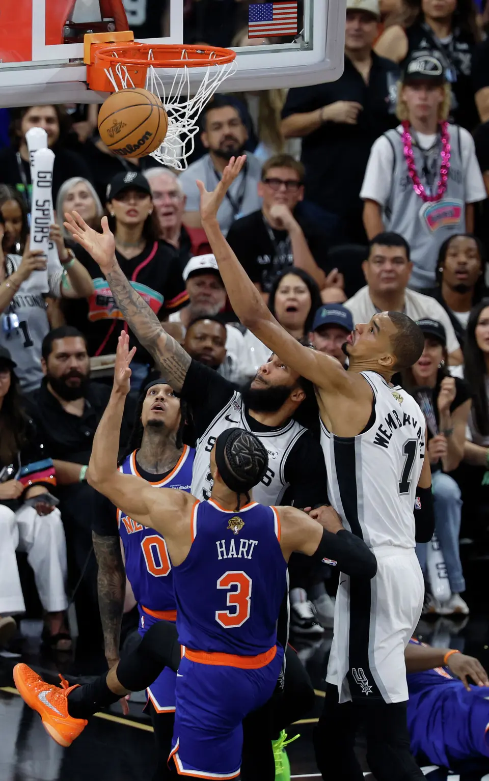 San Antonio Spurs center Victor Wembanyama (1) and San Antonio Spurs forward Julian Champagnie (30) go for a rebound over New York Knicks guard Jordan Clarkson (00) and New York Knicks guard Josh Hart (3) during the third quarter of game five of the NBA Championship at Frost Bank Center on Saturday, June13, 2026.