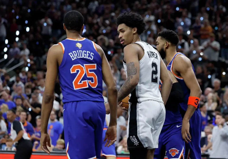 San Antonio Spurs guard Dylan Harper (2)looks over at New York Knicks guard Mikal Bridges (25) during the fourth quarter of game five of the NBA Championship at Frost Bank Center on Saturday, June13, 2026.