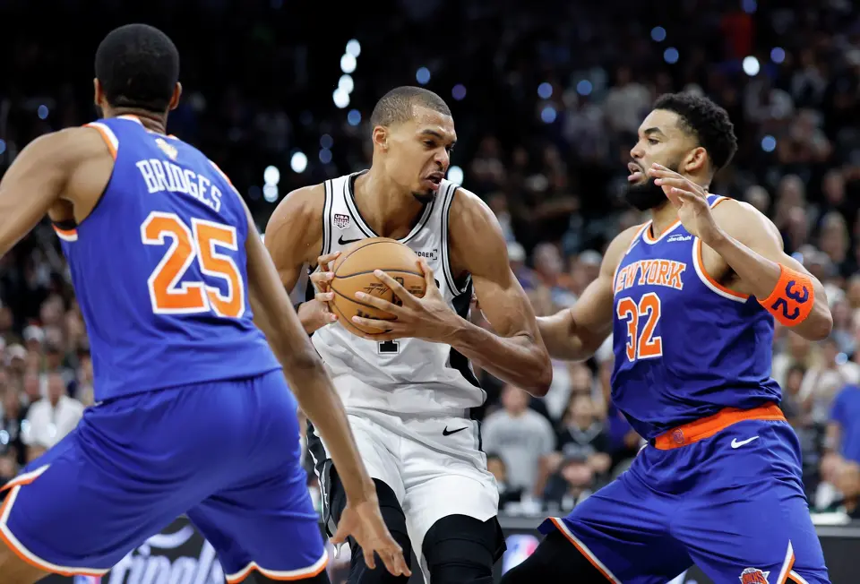 San Antonio Spurs center Victor Wembanyama (1) muscles the ball and looks for an open shot past New York Knicks center Karl-Anthony Towns (32) during the fourth quarter of game five of the NBA Championship at Frost Bank Center on Saturday, June13, 2026.