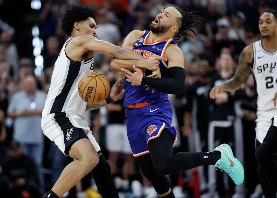 San Antonio Spurs guard Dylan Harper (2) knocks the ball out of the hands of New York Knicks guard Jalen Brunson (11)during the fourth quarter of game five of the NBA Championship at Frost Bank Center on Saturday, June13, 2026.