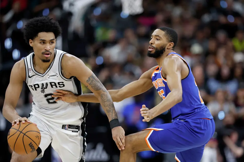 San Antonio Spurs guard Dylan Harper (2) brings the ball up the court as New York Knicks guard Mikal Bridges (25) guards him during the fourth quarter of game five of the NBA Championship at Frost Bank Center on Saturday, June13, 2026.