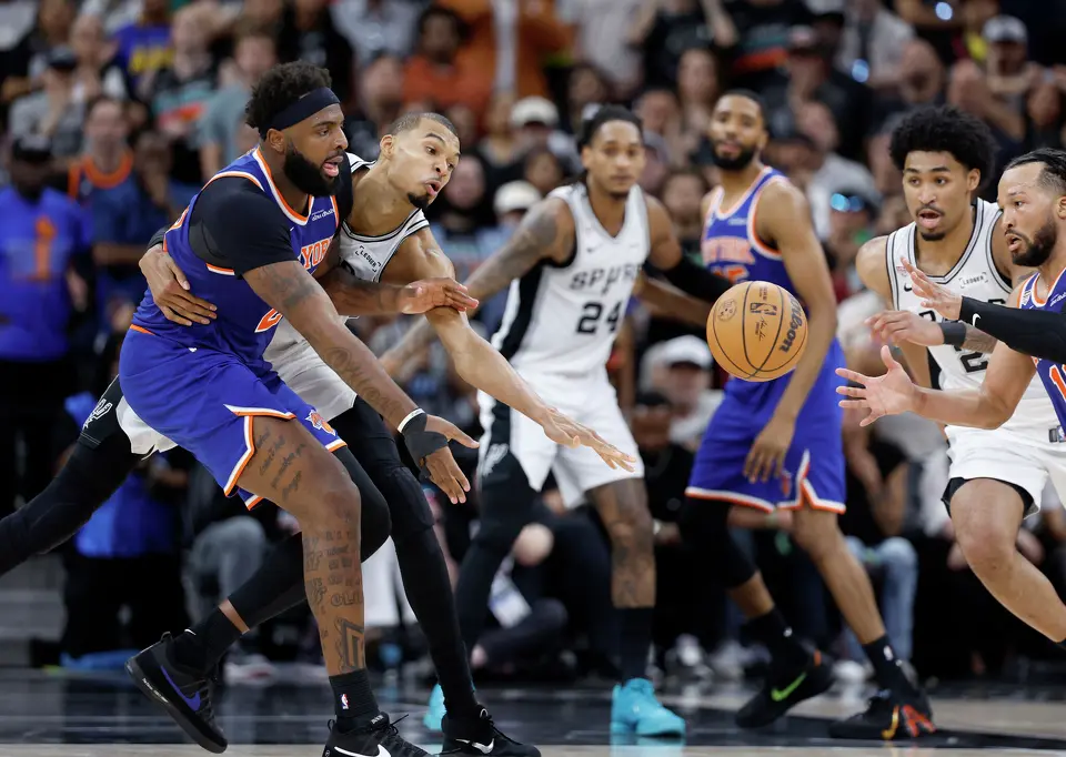 San Antonio Spurs and New York Knicks players go after a loose ball during the fourth quarter of game five of the NBA Championship at Frost Bank Center on Saturday, June13, 2026.