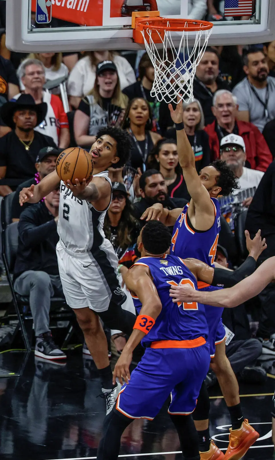 San Antonio Spurs guard Dylan Harper (2) walks the baseline and delivers a reverse layup over New York Knicks guard Landry Shamet (44) during the first quarter of game five of the NBA Championship at Frost Bank Center on Saturday, June13, 2026.
