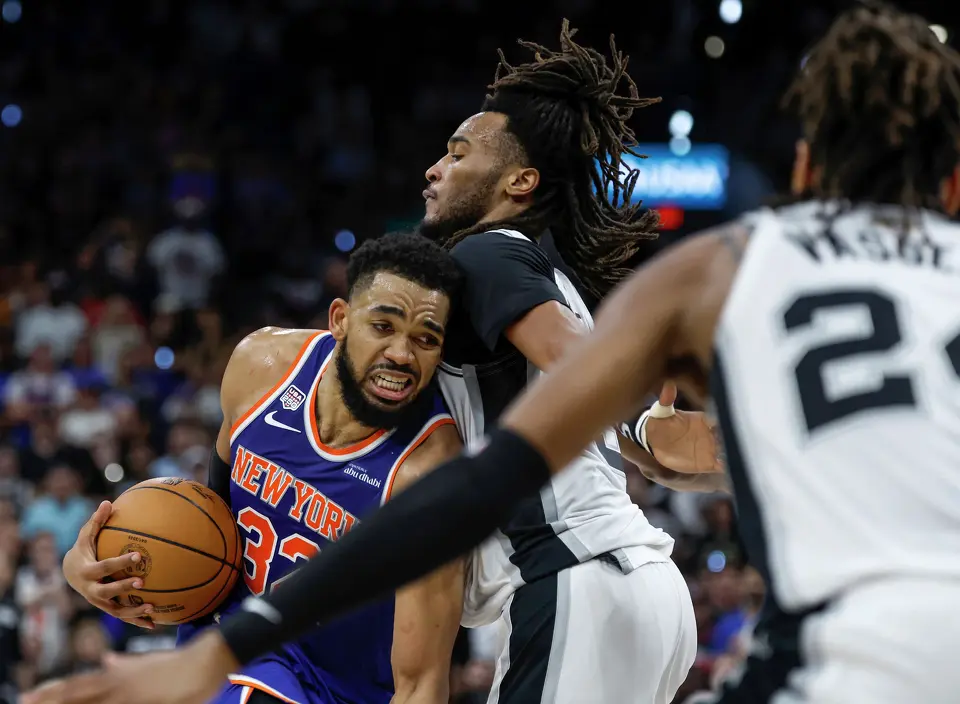 New York Knicks center Karl-Anthony Towns (32) struggles to get past San Antonio Spurs guard Stephon Castle (5) during the second quarter of game five of the NBA Championship at Frost Bank Center on Saturday, June13, 2026.
