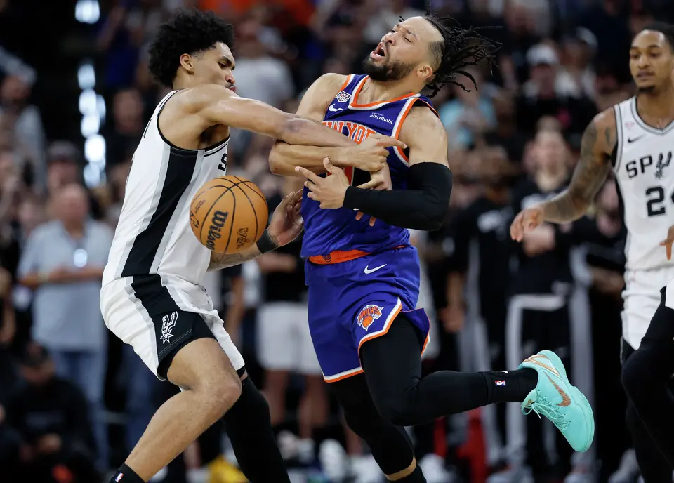 San Antonio Spurs guard Dylan Harper (2) knocks the ball out of the hands of New York Knicks guard Jalen Brunson (11)during the fourth quarter of game five of the NBA Championship at Frost Bank Center on Saturday, June13, 2026.