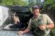Wildlife Officer Cameron Blechert stands next to the deer.