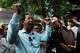 Rong Chhun, a prominent Cambodian opposition politician, gestures to his supporters after a Supreme Court hearing in Phnom Penh, Cambodia, Monday, June 15, 2026.