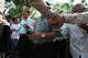 Security guards barricade hand-in-hand for protecting Rong Chhun, a prominent Cambodian opposition politician, back left, as he walks together with his supporters through a public park after a Supreme Court hearing in Phnom Penh, Cambodia, Monday, June 15, 2026.