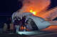 People attempt to pull passengers out of a plane after it crashed on a highway Tuesday, June 16, 2026, in Laredo, Texas. (Zayra Garza via AP)