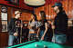 Patrons wearing Bus Stop merch at the bar in San Francisco.