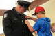 East Alton Police Sgt. Wesley Hockaday's son Hunter pins on his dad's new badge during the Village Board Meeting on J...