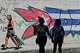 People walk past graffiti in the colors of the Cuban flag in Havana, Cuba, Wednesday, June 17, 2026.