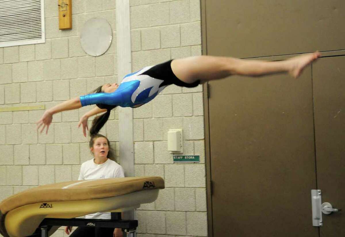 Staples' Morgan Cravenho does a vault as Weston High School hosts Staples High School for a gymnastics competition at Weston Middle School in Weston, CT on Tuesday, December 21, 2010.