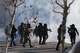 FILE - Federal immigration officers deploy tear gas at protesters after a shooting Jan. 24, 2026, in Minneapolis.