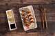 Sushiya's Firecracker Roll comes with cream cheese, tempura shrimp, and avocado, topped with spicy mayo and spicy crunchies.