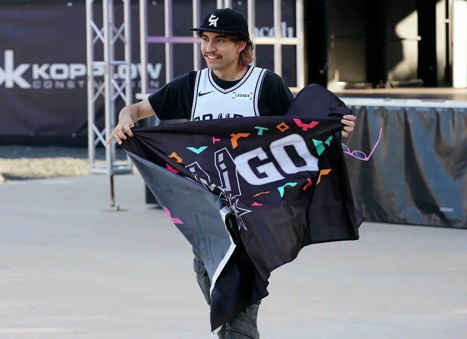 Alex Falcon smiles after winning a Spurs flag duringTuesday's NBA Draft Party at the Victory Performance Center.