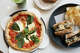 An margherita pizza from Campo and a vegetarian Foristier sandwich from Cuisine at Omakase World Market in South San Francisco Calif., June 23, 2026.