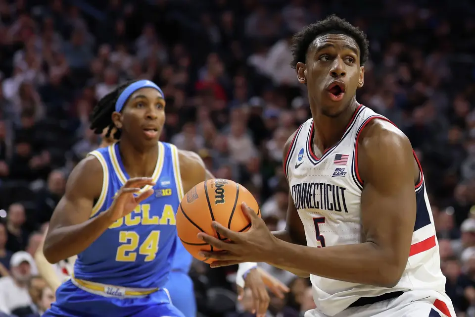 Tarris Reed Jr. (5) of the UConn Huskies posts up against Steven Jamerson II (24) of the UCLA Bruins during the second half in the second round of the 2026 NCAA Men's Basketball Tournament at Xfinity Mobile Arena on Sunday, March 22, 2026, in Philadelphia. (Emilee Chinn/Getty Images/TNS)