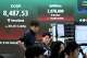 Currency traders work near a screen showing the Korea Composite Stock Price Index (KOSPI) at the foreign exchange dealing room of the Hana Bank headquarters in Seoul, South Korea, Wednesday, June 24, 2026.