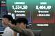 A currency trader watches monitors near a screen showing the Korea Composite Stock Price Index (KOSPI) and the foreign exchange rate between U.S. dollar and South Korean won at the foreign exchange dealing room of the Hana Bank headquarters in Seoul, South Korea, Wednesday, June 24, 2026.