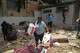People take goods from damaged stores a day after earthquakes and aftershocks struck Catia La Mar, Venezuela, Thursday, June 25, 2026.