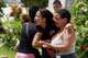 Neighbors comfort Gabriela Rojas, center, as she mourns in front of her damaged home, where two of her children died during earthquakes that struck La Guaira, Venezuela, Thursday, June 25, 2026..