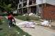 A man looks at covered bodies in front of a damaged building the day after earthquakes and several aftershocks struck La Guaira, Venezuela, Thursday, June 25, 2026.