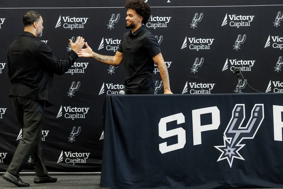 San Antonio Spurs general manager Brian Wright greets Spurs rookie Ja’Kobi Gillespie during a news conference at Victory Capital Performance Center in San Antonio, Thursday, June 25, 2026.