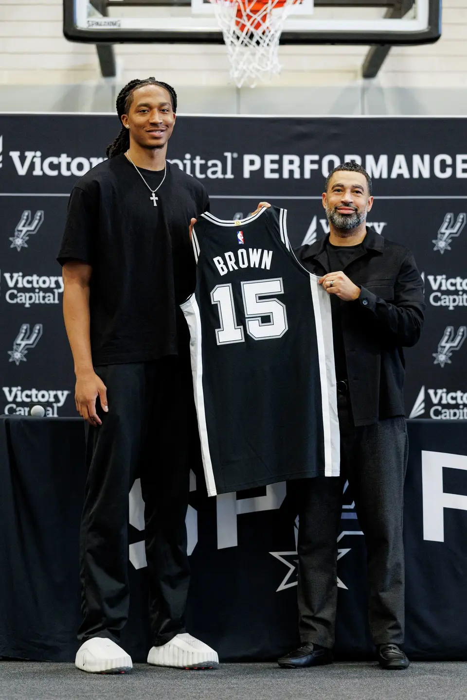 San Antonio Spurs rookie Maliq Brown poses for a picture with Spurs general manager Brian Wright during a news conference at Victory Capital Performance Center in San Antonio, Thursday, June 25, 2026.