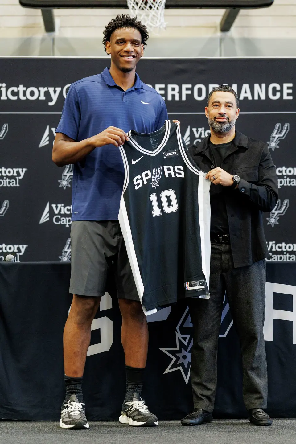 San Antonio Spurs rookie Tarris Reed Jr. poses for pictures with Spurs general manager Brian Wright during a news conference at Victory Capital Performance Center in San Antonio, Thursday, June 25, 2026.