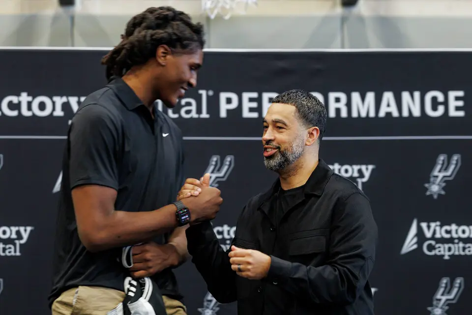 San Antonio Spurs rookie Jayden Quaintance shakes hands with Spurs general manager Brian Wright during a news conference at Victory Capital Performance Center in San Antonio, Thursday, June 25, 2026.