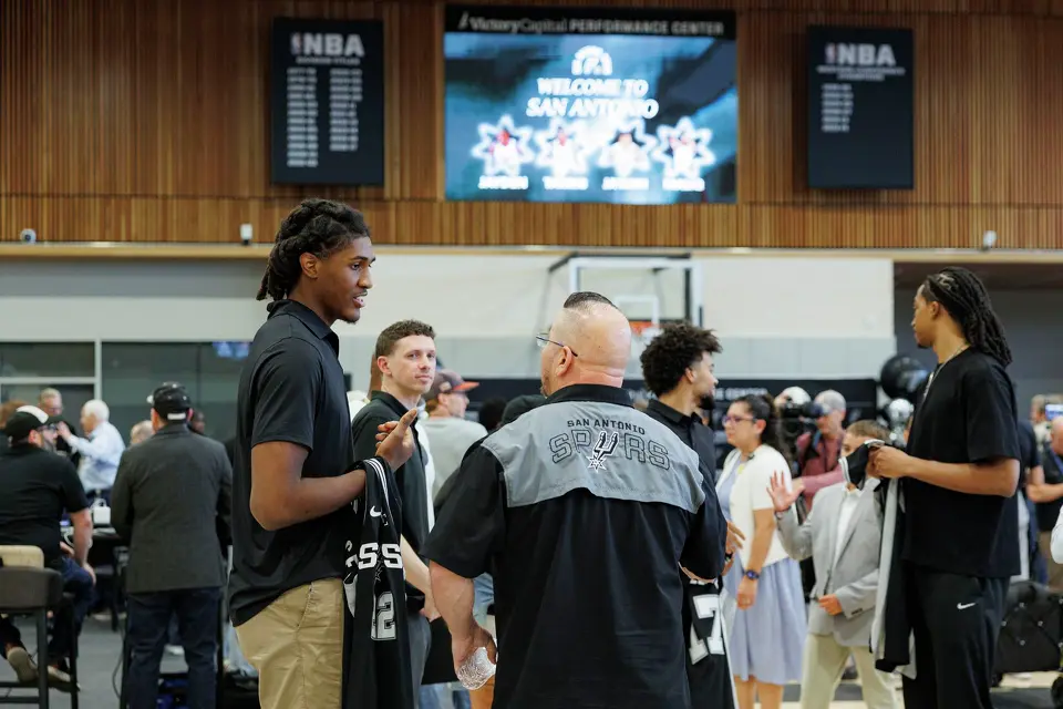 Spurs rookie Jayden Quaintance talks with a small crowd of people following an introductory news conference at Victory Capital Performance Center, Thursday, June 25, 2026, in San Antonio.