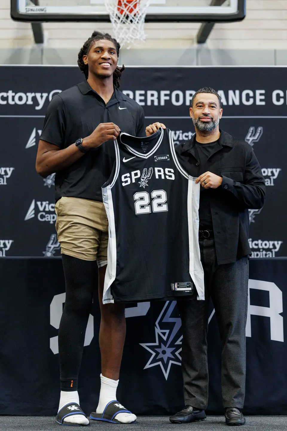 San Antonio Spurs rookie Jayden Quaintance poses for pictures with Spurs general manager Brian Wright during a news conference at Victory Capital Performance Center in San Antonio, Thursday, June 25, 2026.