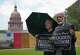 Mohammed Nasrullah, left, and Aziz Soomro, both of Houston, participate in an interfaith funeral-themed protest outside the Barbara Jordan Building in Austin on Monday, June 22, 2026. (Jay Janner/Austin American-Statesman via AP)