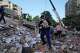 Residents search through the rubble of a building that collapsed in an earthquake in Caracas, Venezuela, Thursday, June 25, 2026.