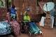 Noon Madani, 18, center, who was injured in a shelling attack, sits in a wheelchair on the patio of her family home in Khartoum, Monday, April 27, 2026.